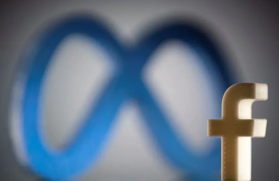 A small golden Facebook logo stands in the foreground, with a blurred, large blue Meta logo in the background.