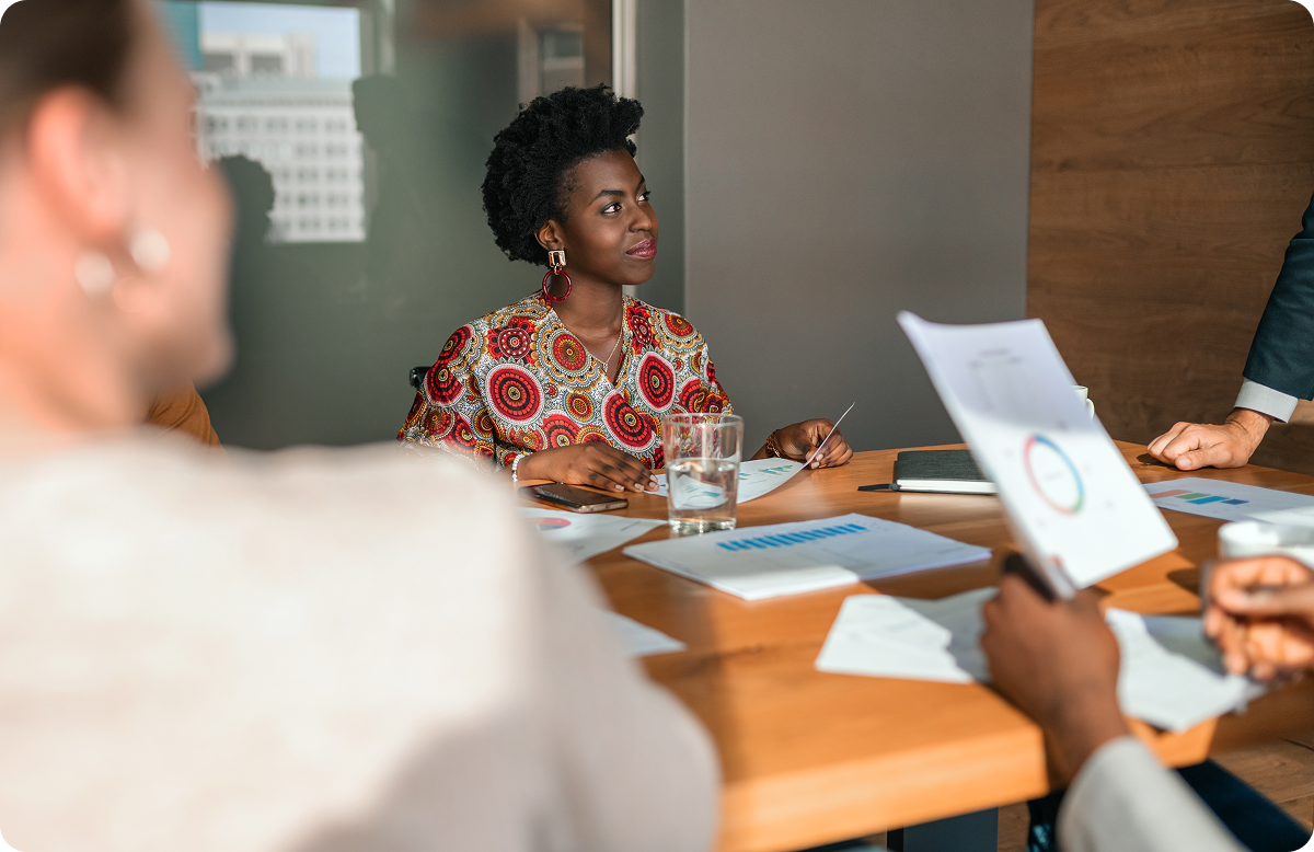 Young black professional woman listening intently in a company meeting