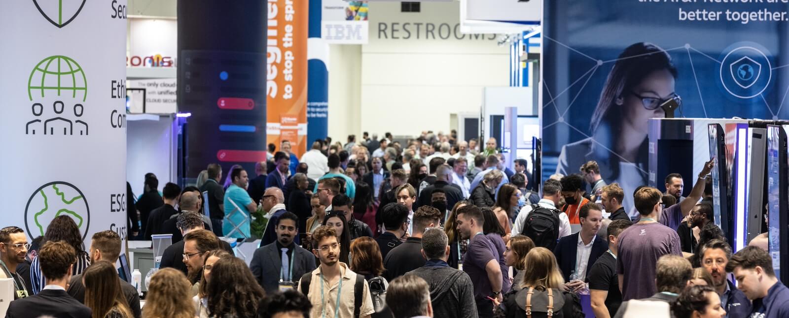 View of busy tradeshow floor with many professionals in attendance