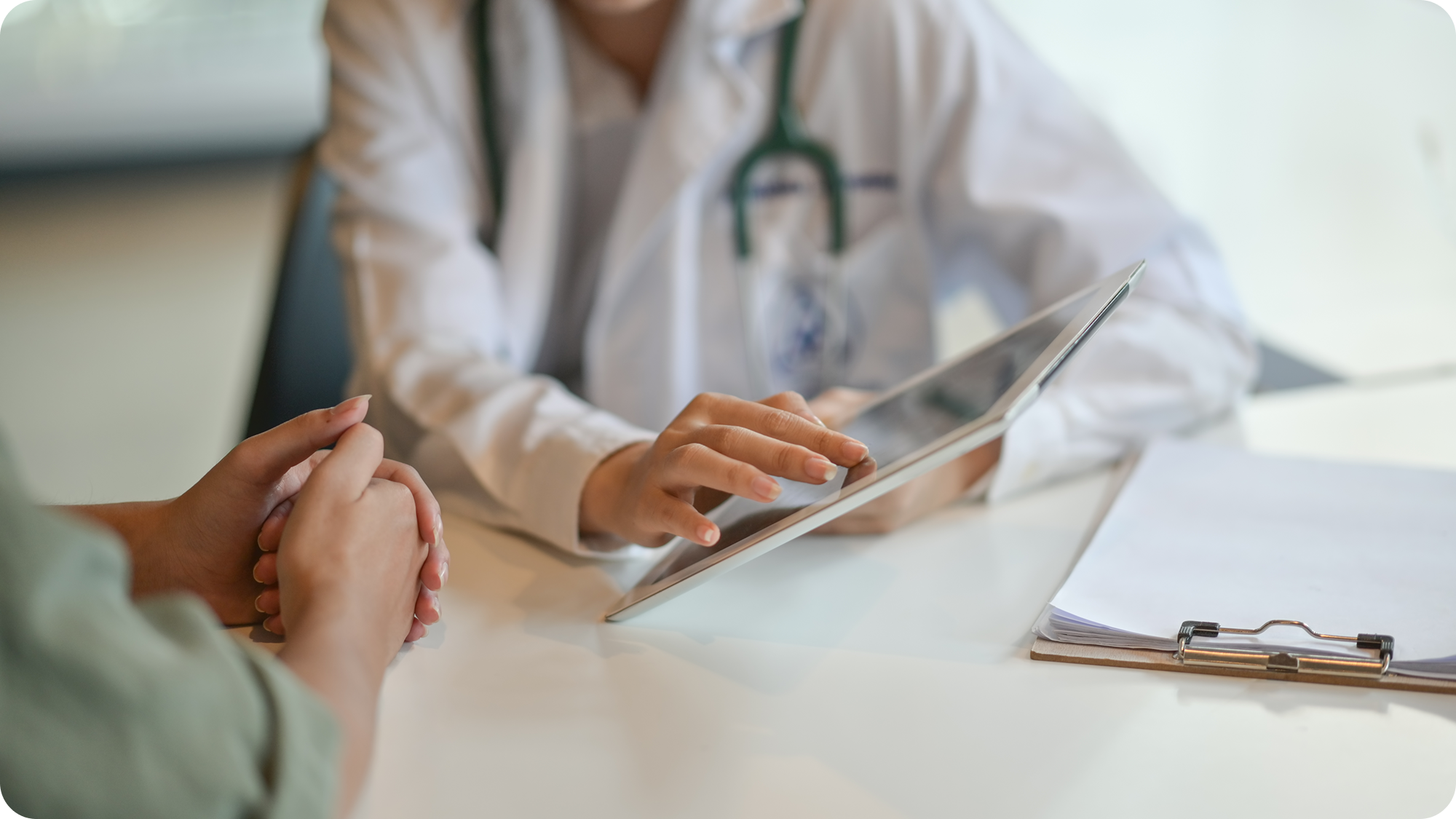 Close up a doctor and patients hands going over patient health data