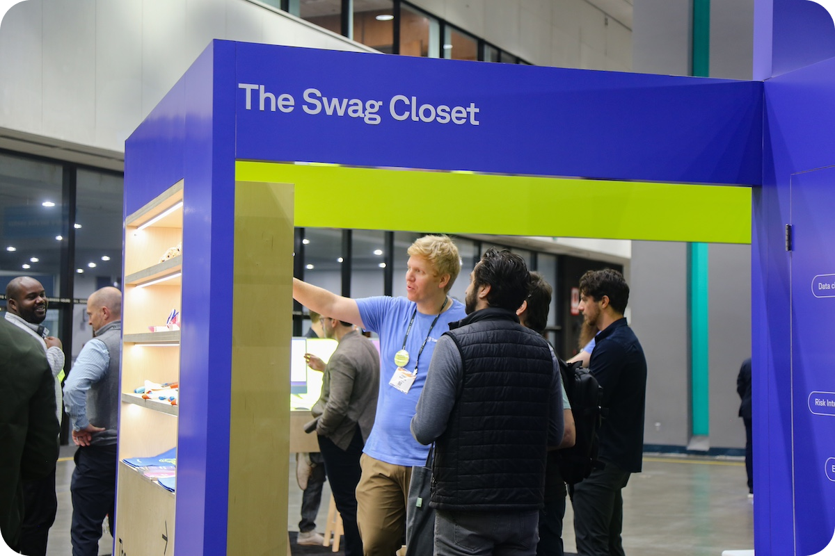 Vendor at trade show showing off a brightly colored display labeled the Swag Closet