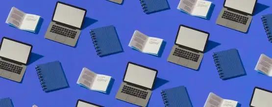 Series of laptops, notebooks, and books on blue background