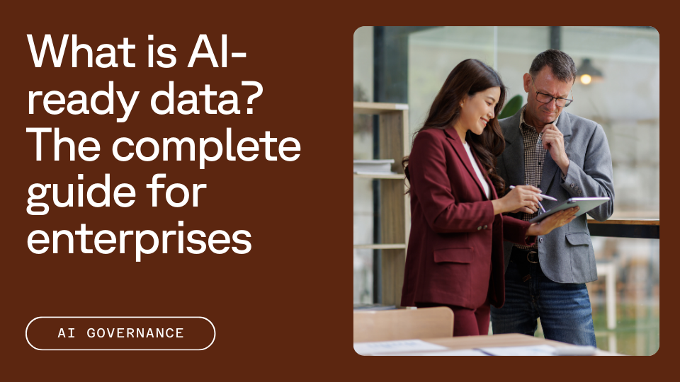 Two people discussing information displayed on a tablet, one person pointing at the screen while the other observes thoughtfully. Text reads: "What is AI-ready data? The complete guide for enterprises" with a note on "AI Governance."