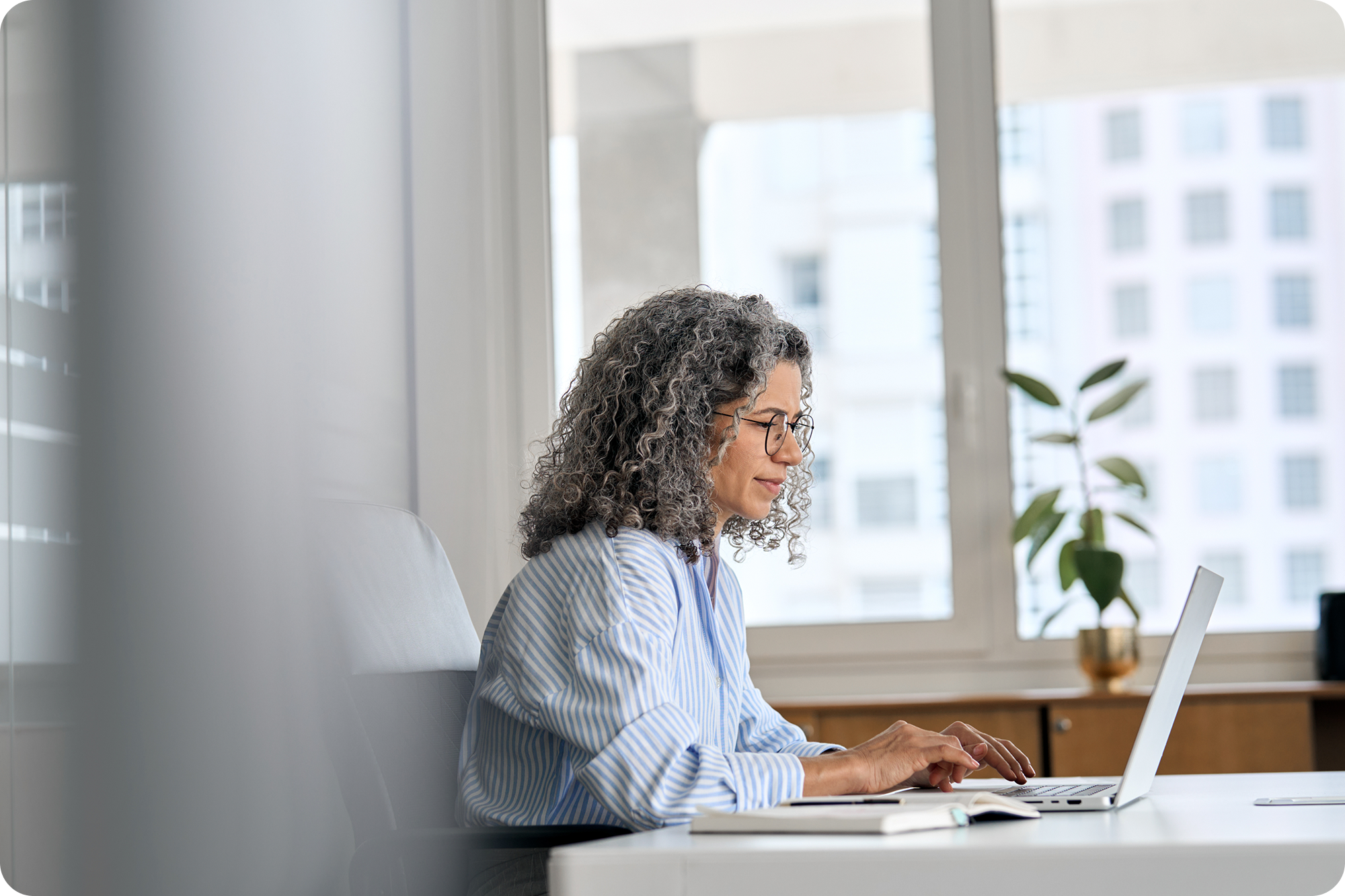 Mature woman working on a laptop in an office