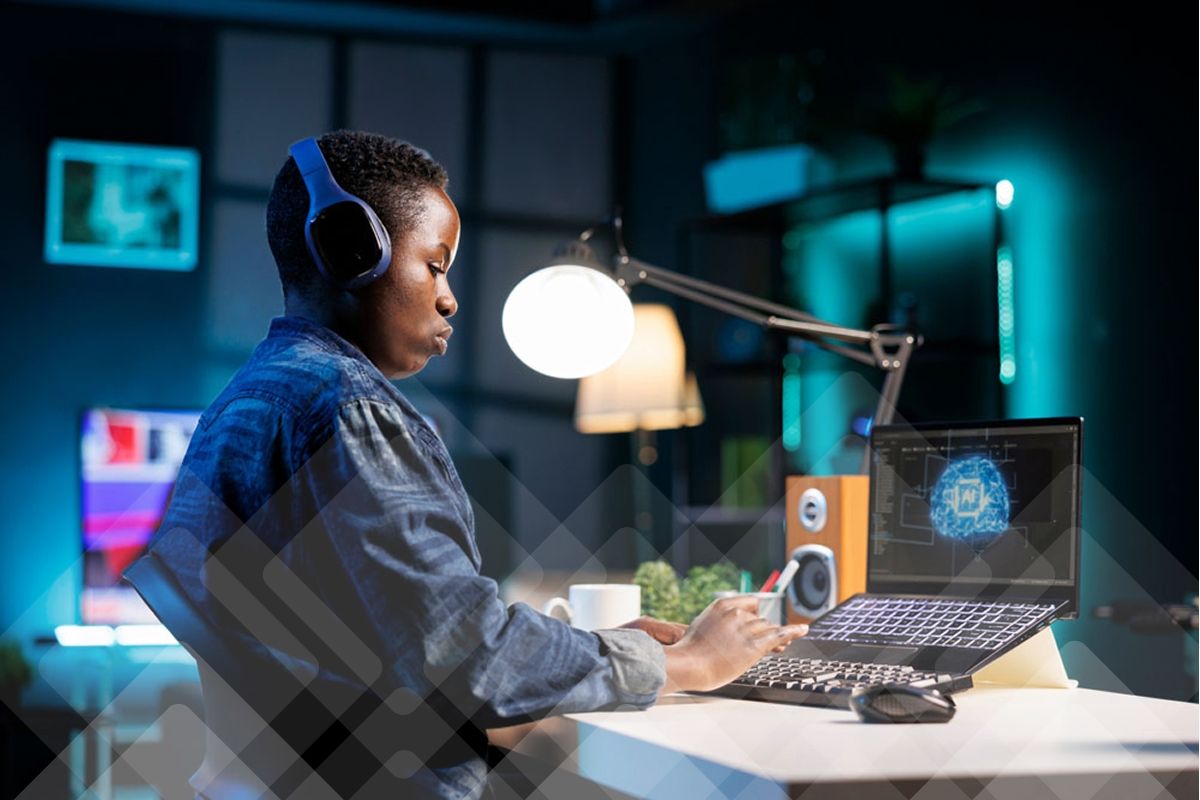 A person wearing headphones works on a laptop displaying an AI graphic.