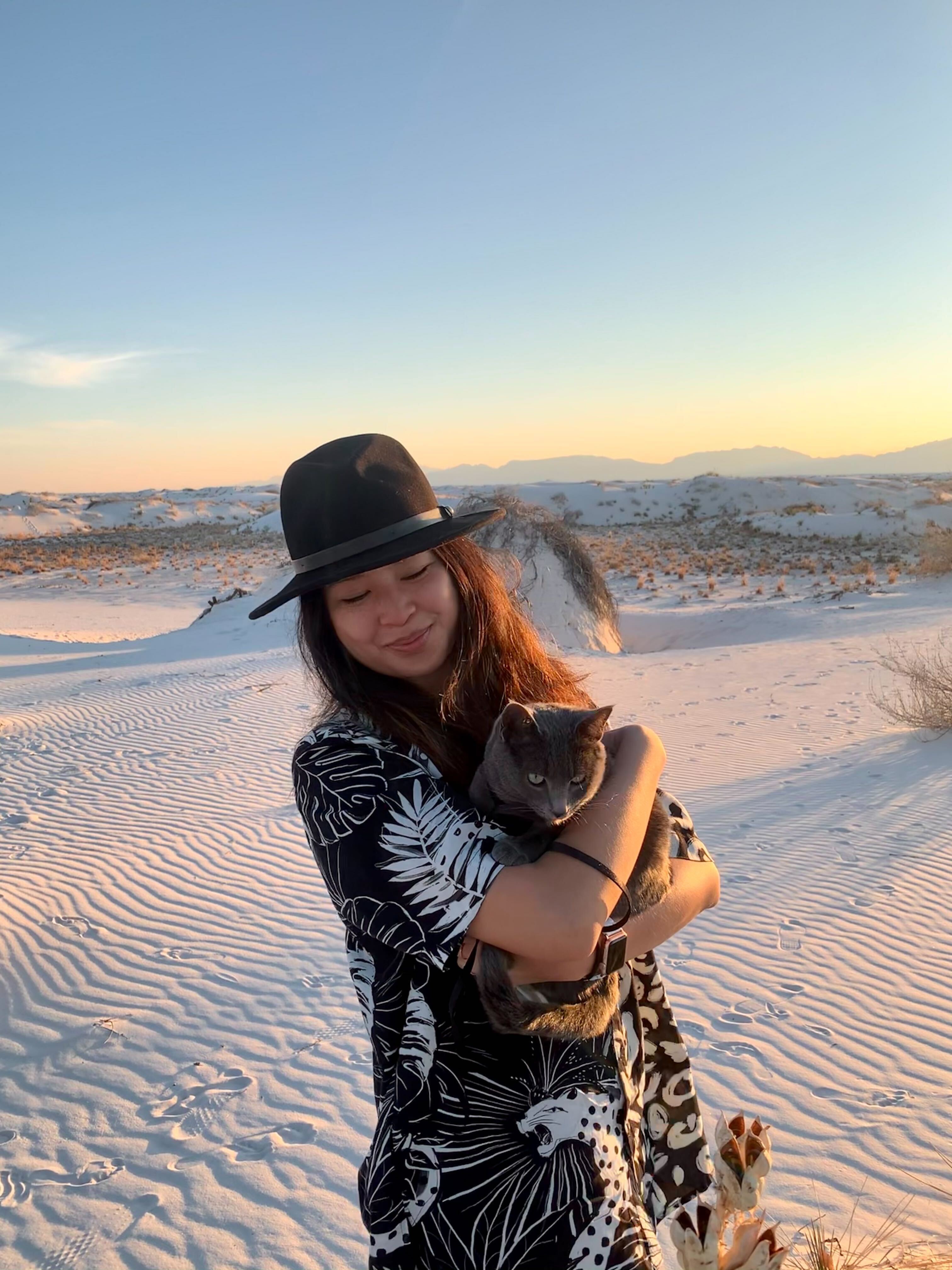 Phyllis Fang holding her cat in the desert