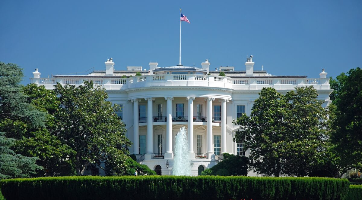 The White House with flag flying and fountain going
