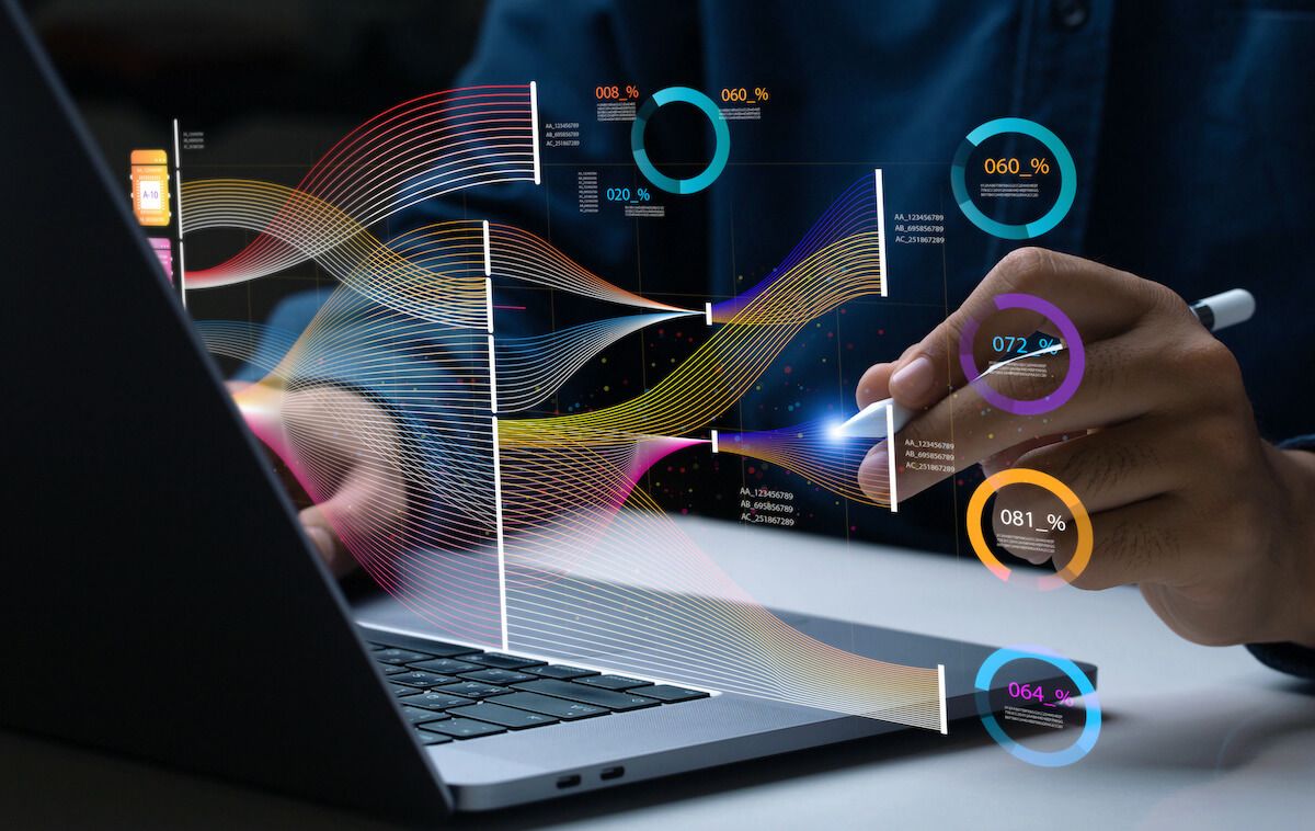 Closeup of person using an apple pencil to conduct data classification on their laptop