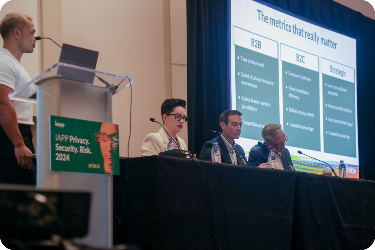 Ron De Jesus moderating at panel at IAPP P.S.R. Speakers are Lauren Reid, Avishai Ostrin, and Aaron Weller. Screen behind the panelists says 'The metrics that really matter.'