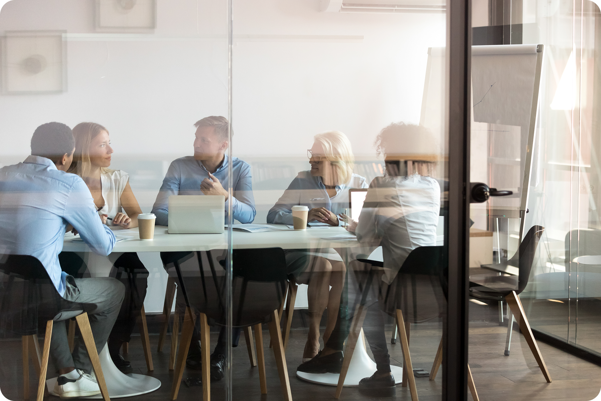 A group of professionals holding a meeting in a conference room