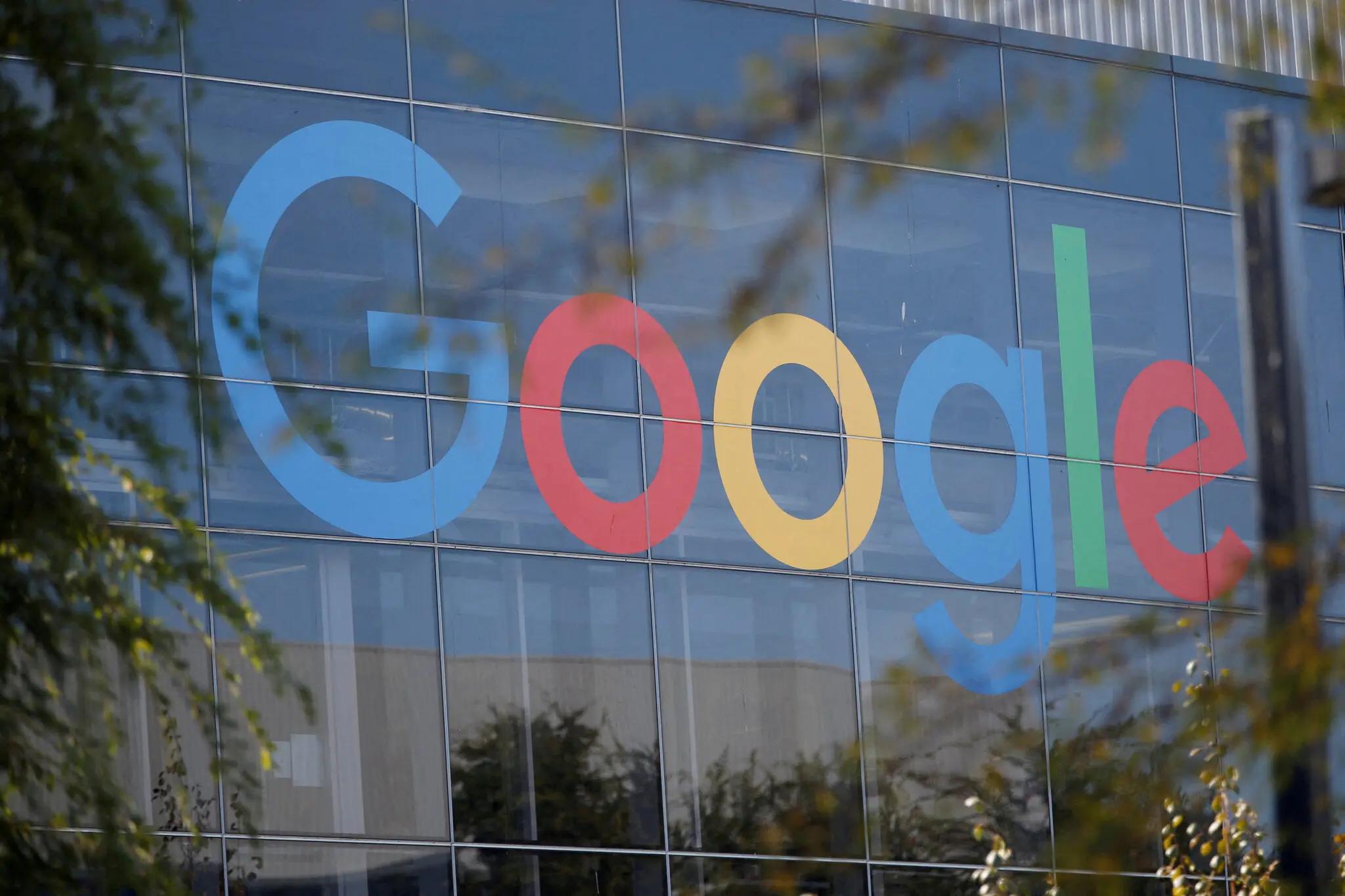 The Google logo is prominently displayed in large colorful letters on the glass facade of a modern building.