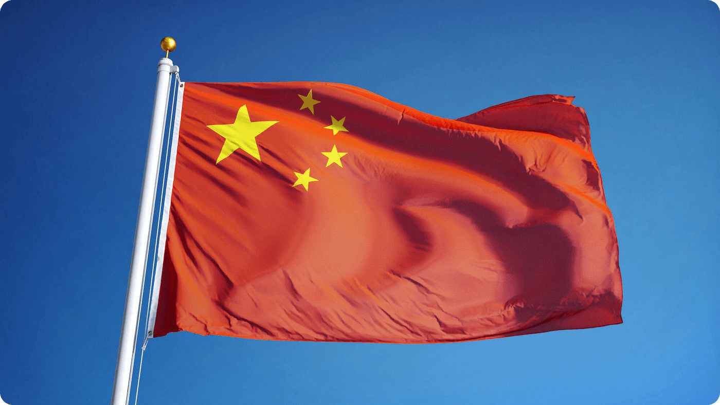 The chinese flag waving in front of blue background
