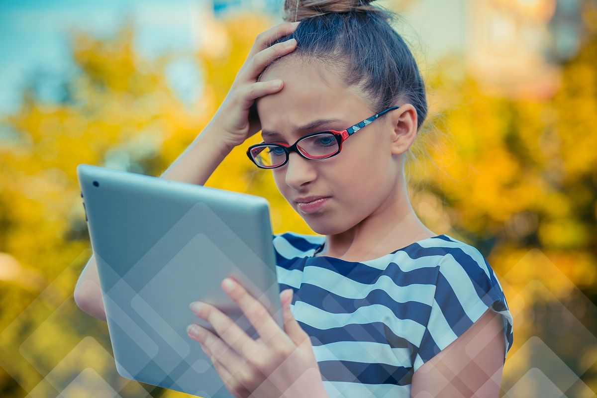 A young girl with glasses looks confused, holding a tablet with a hand on her forehead.