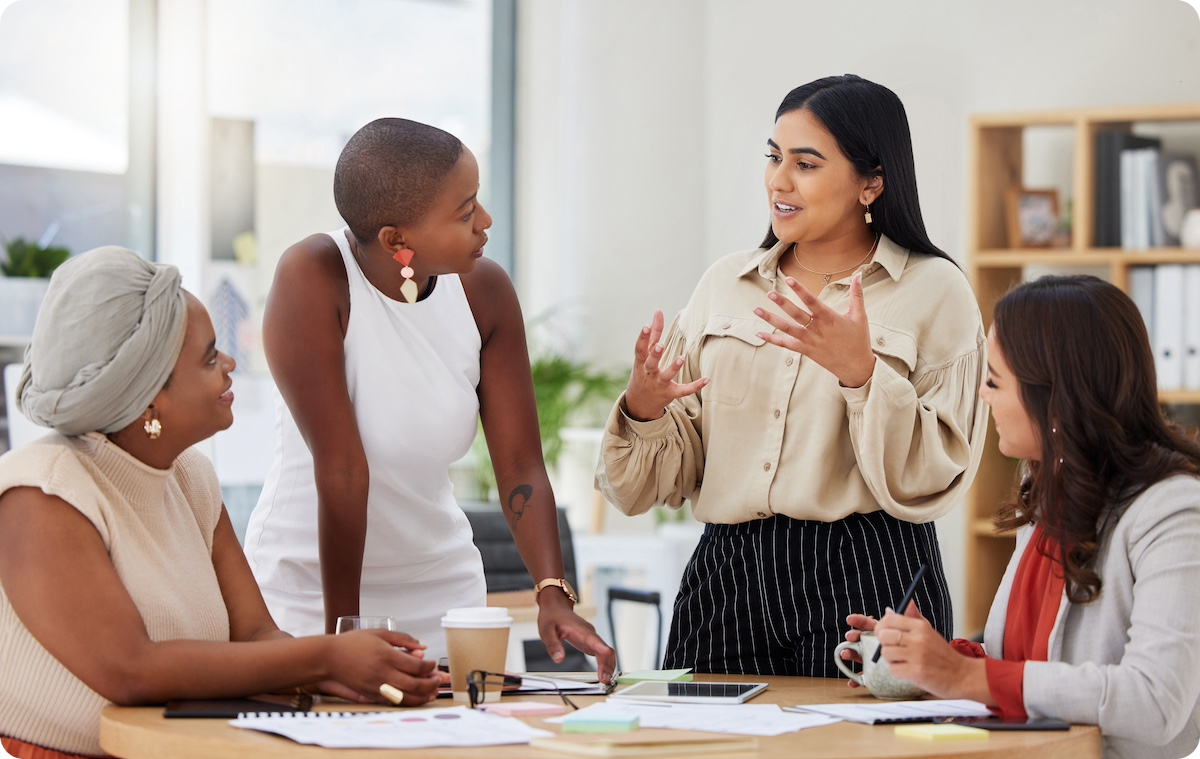 Group of professional women collaborating around office table