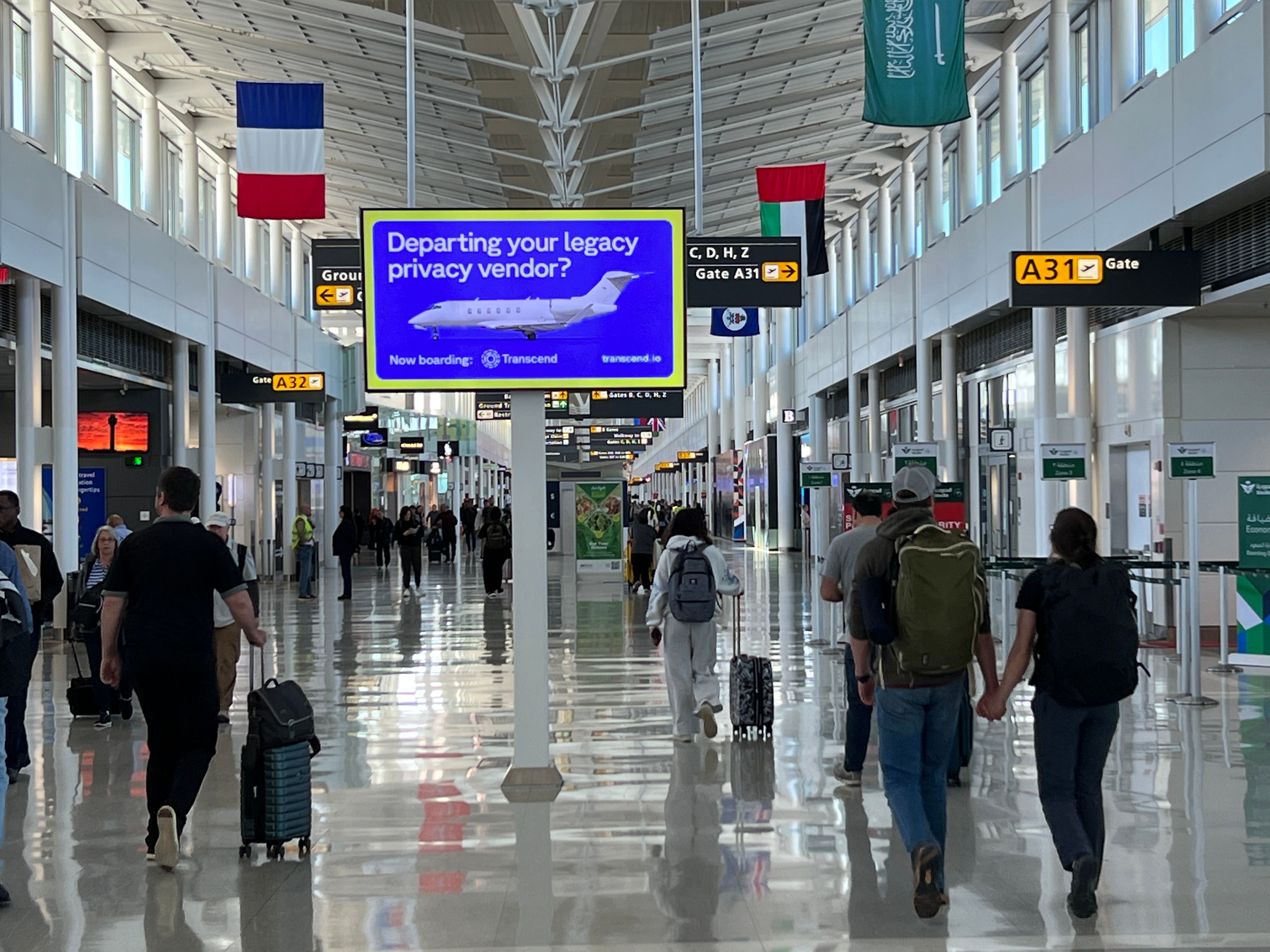 View of an airport with transcend display advertisement on screen reading departing your legacy privacy vendor
