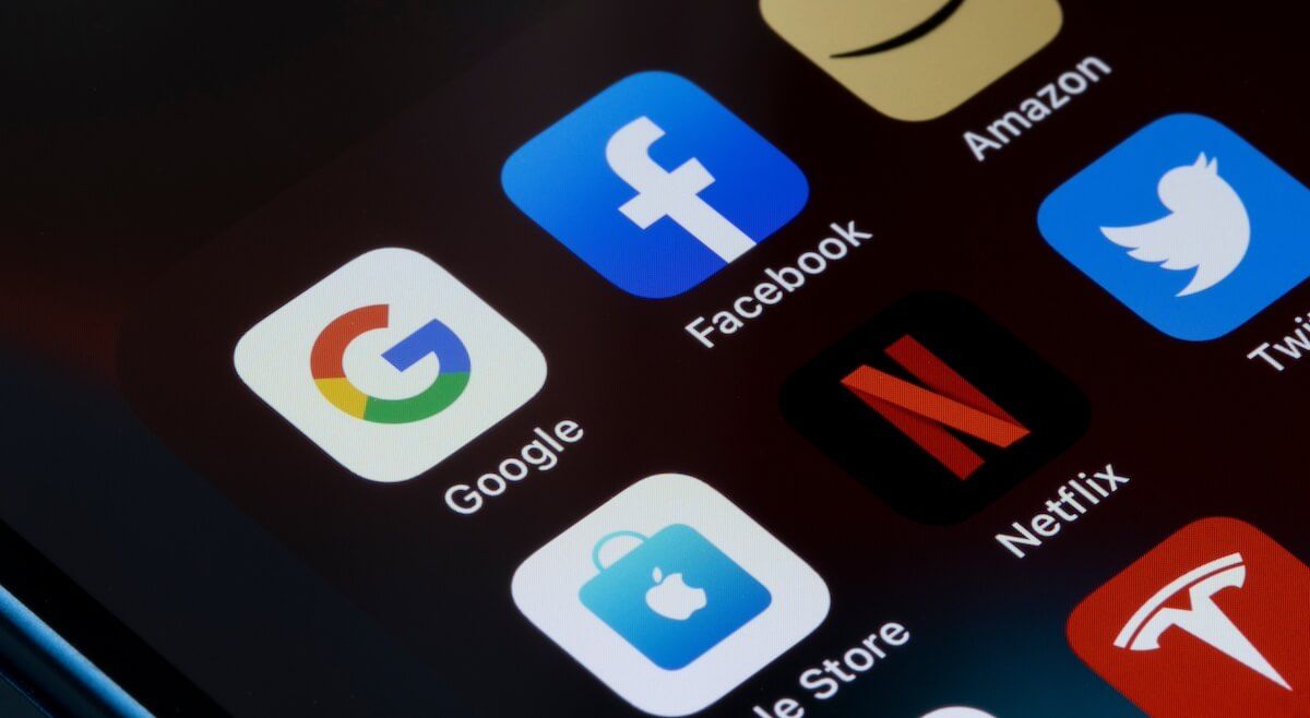 Closeup of an iphone screen focused on the Google and facebook apps