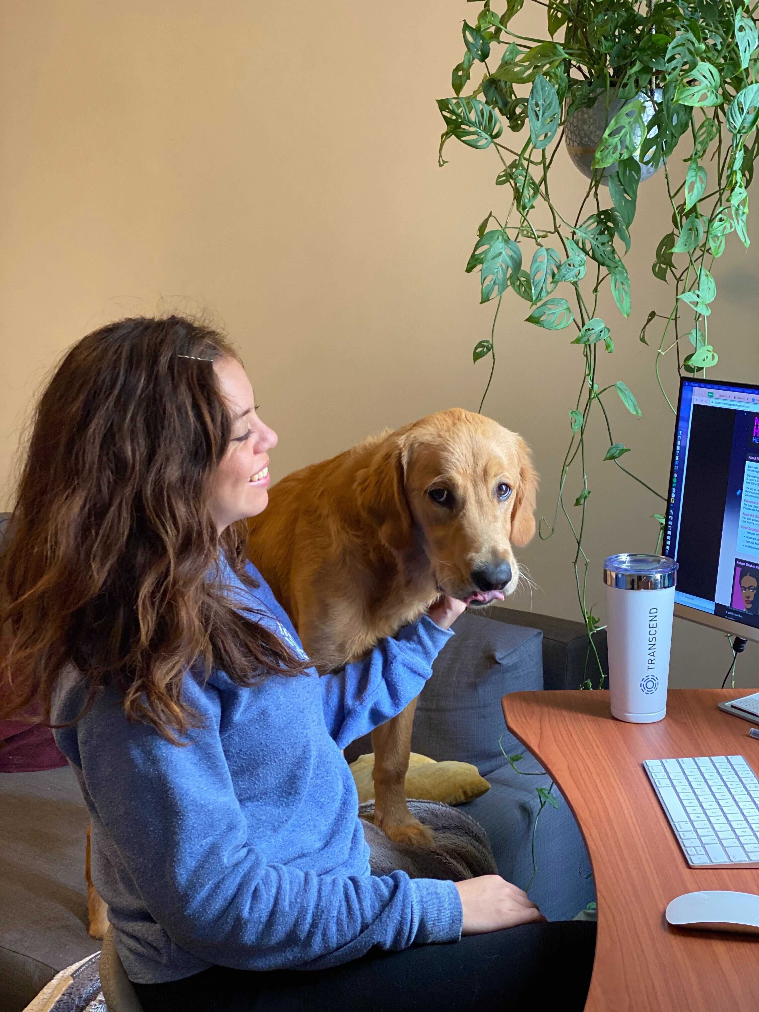 Nancy Fonseca at her desk with her dog Oso
