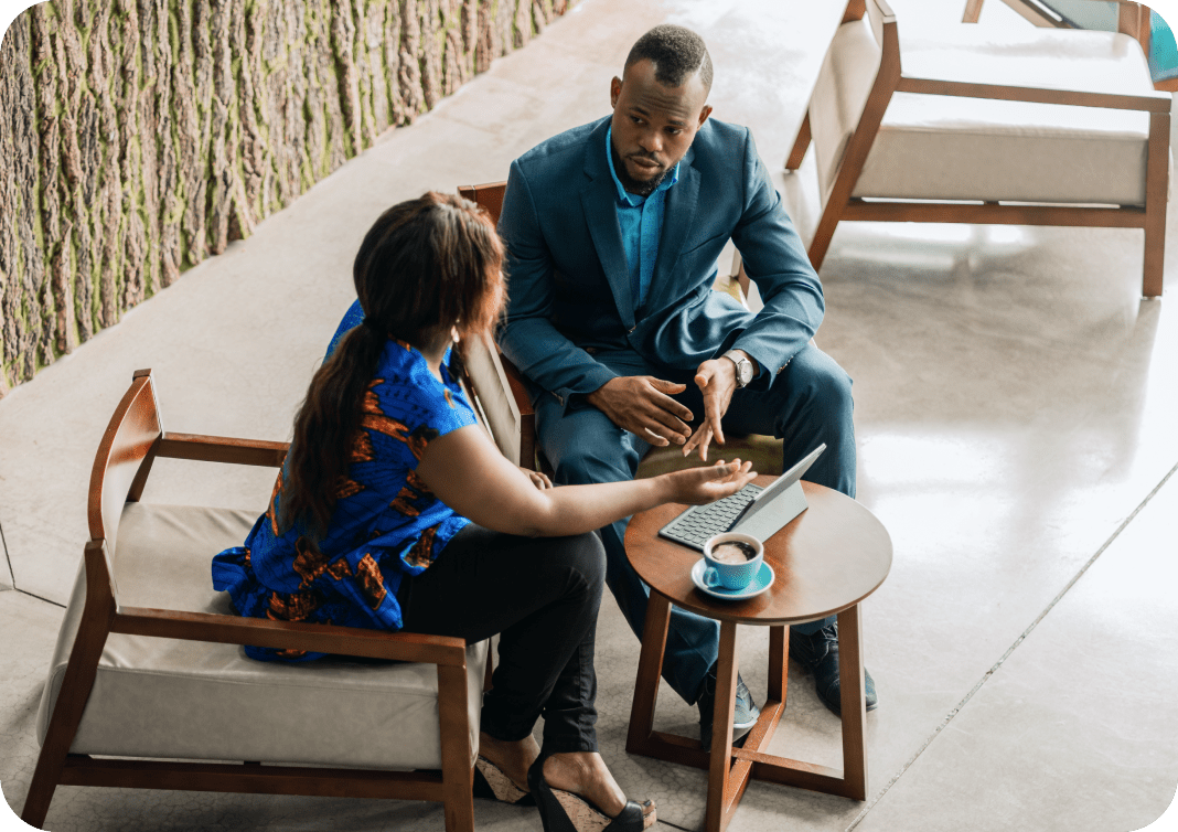 Photograph of two professionals chatting over coffee
