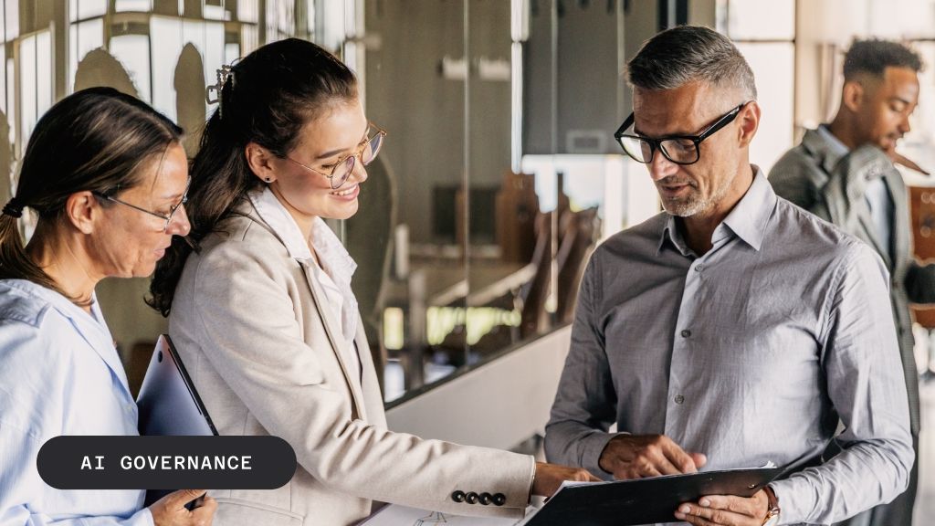 Three business professionals reviewing documents, with "AI GOVERNANCE" text overlay.