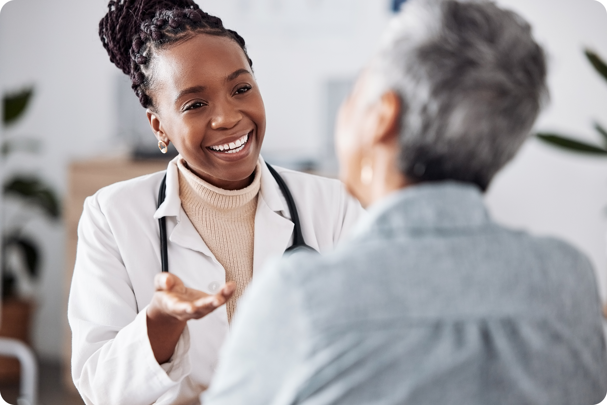 Doctor smiling while explaining to something to a patient