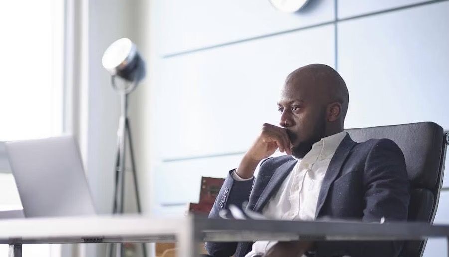 Photo of a person staring at a computer monitor.