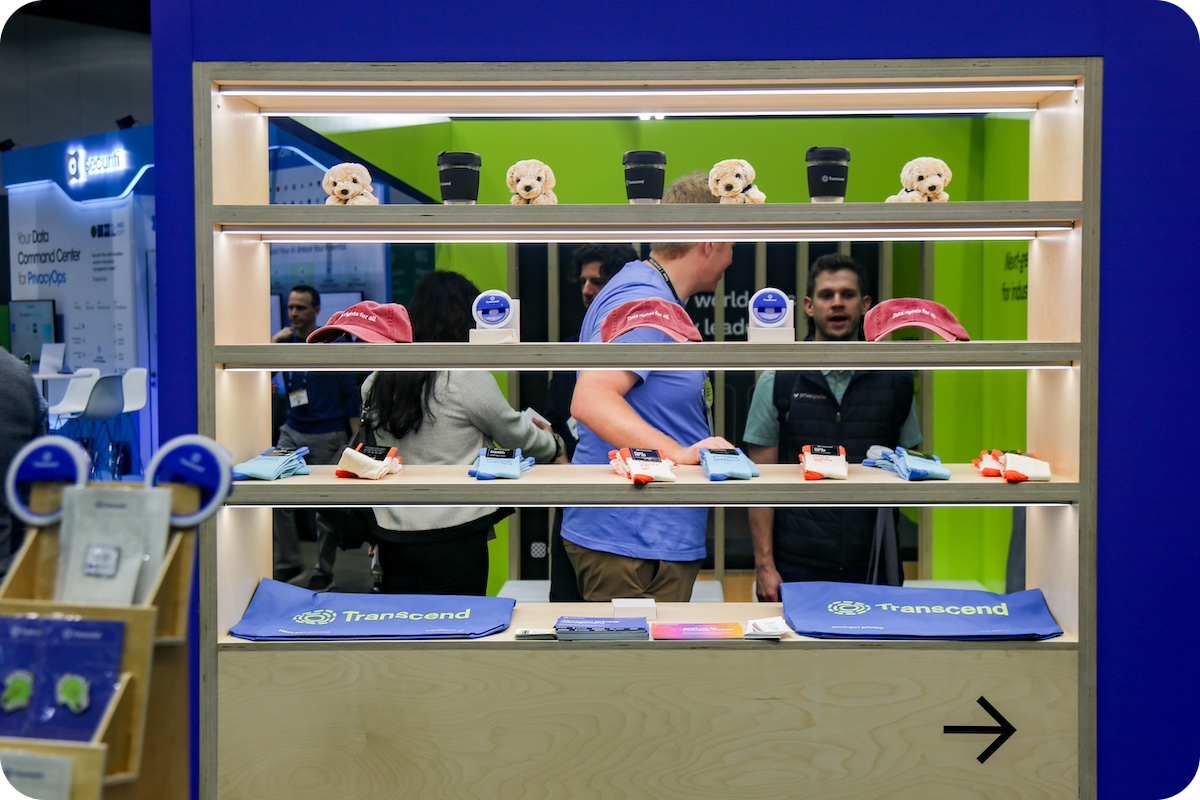 Vendor booth at trade show showing off swag giveaway items such as hats and plush animals