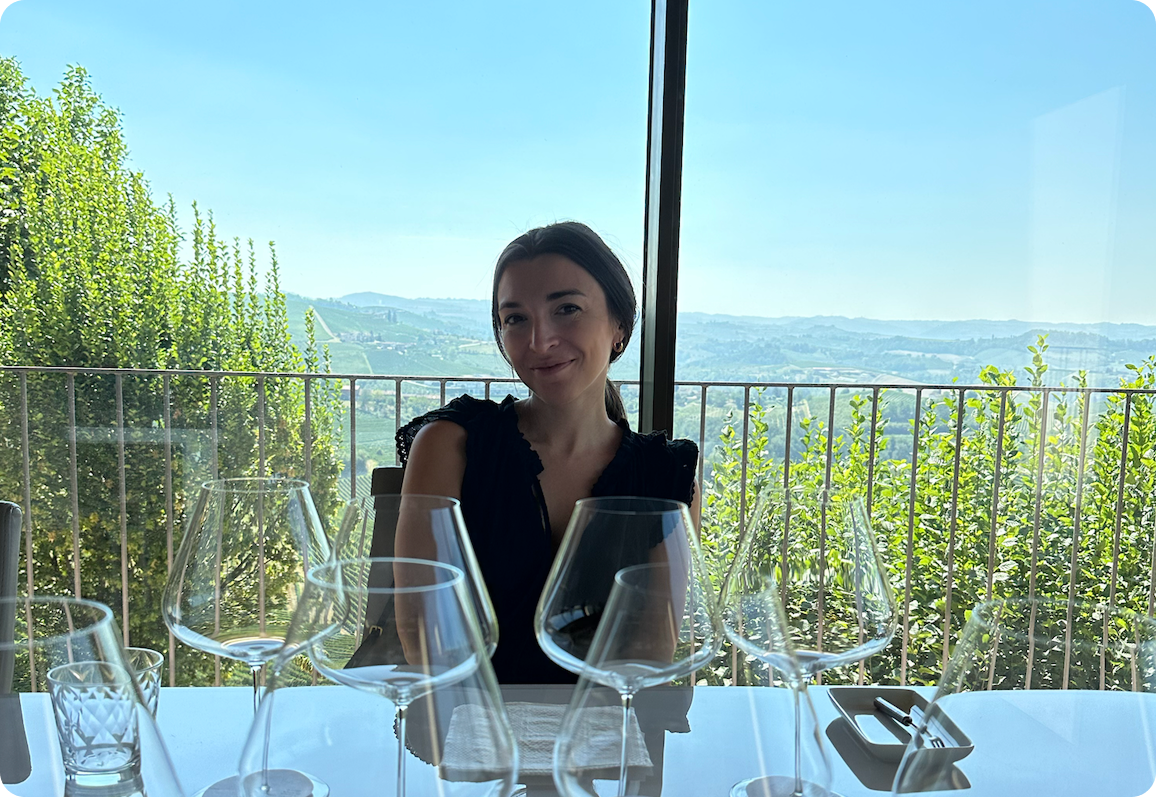 Jess Bronowicki, Head of Sales Engineering at Transcend, sitting at a table with a beautiful mountain background behind her