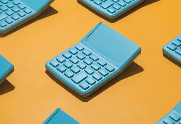 Series of teal calculator shaped objects on an orange background