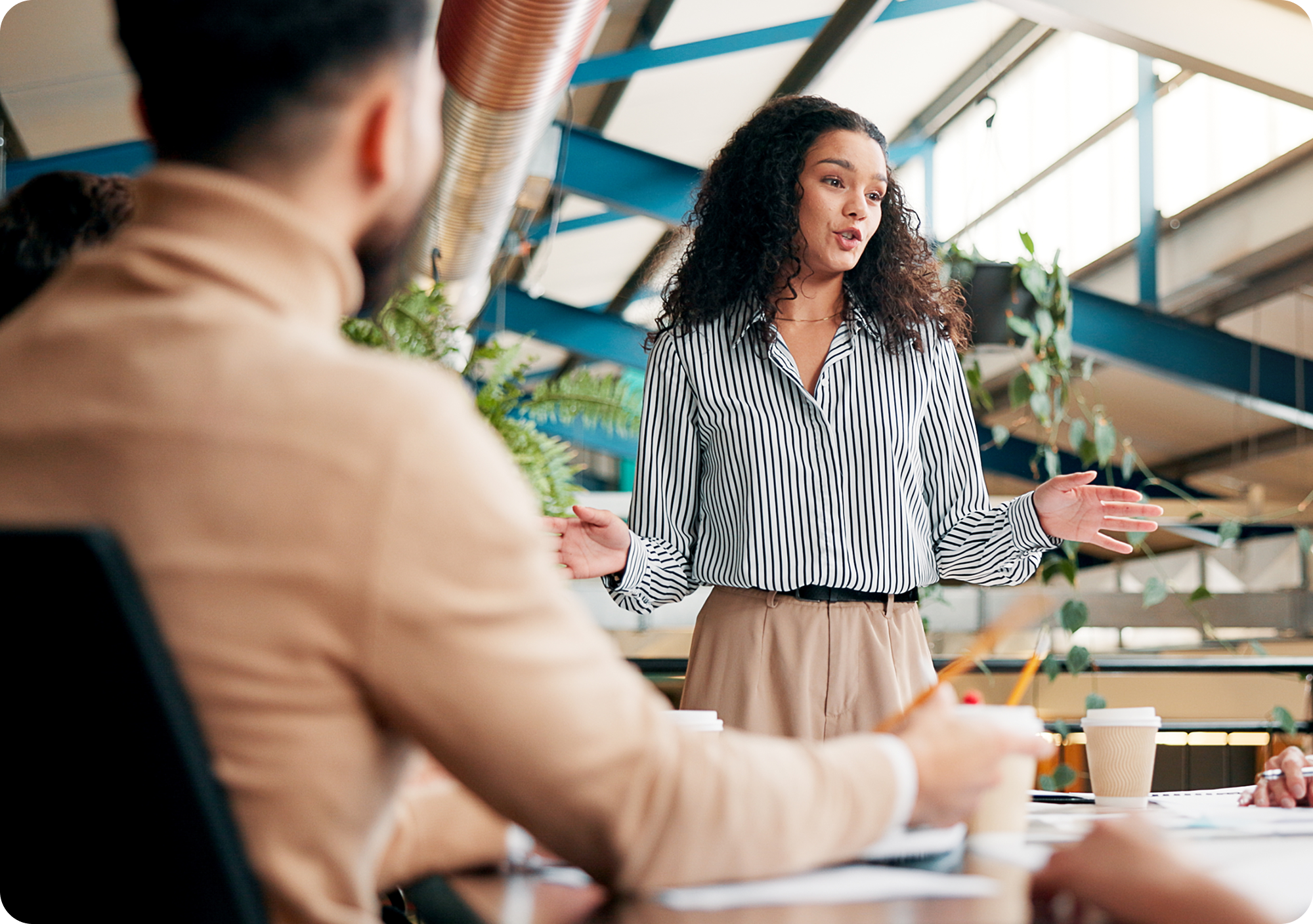 Marketing executive gesturing and talking in a team meeting