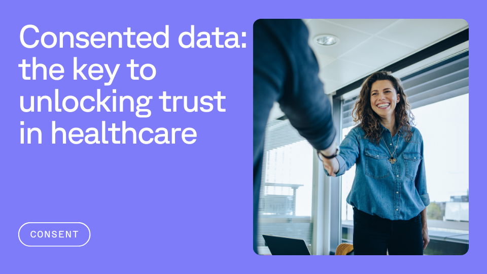 A smiling woman in a denim shirt shakes hands with someone, set in a modern office environment. Bold text reads, "Consented data: the key to unlocking trust in healthcare."