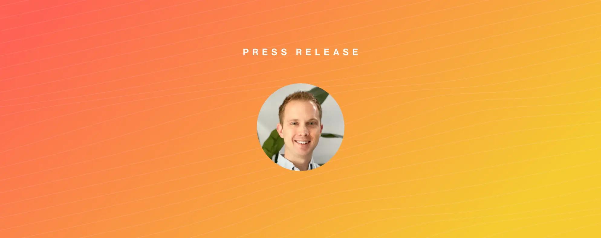 Headshot of smiling man in front of red and yellow wavy background with text reading Press Release