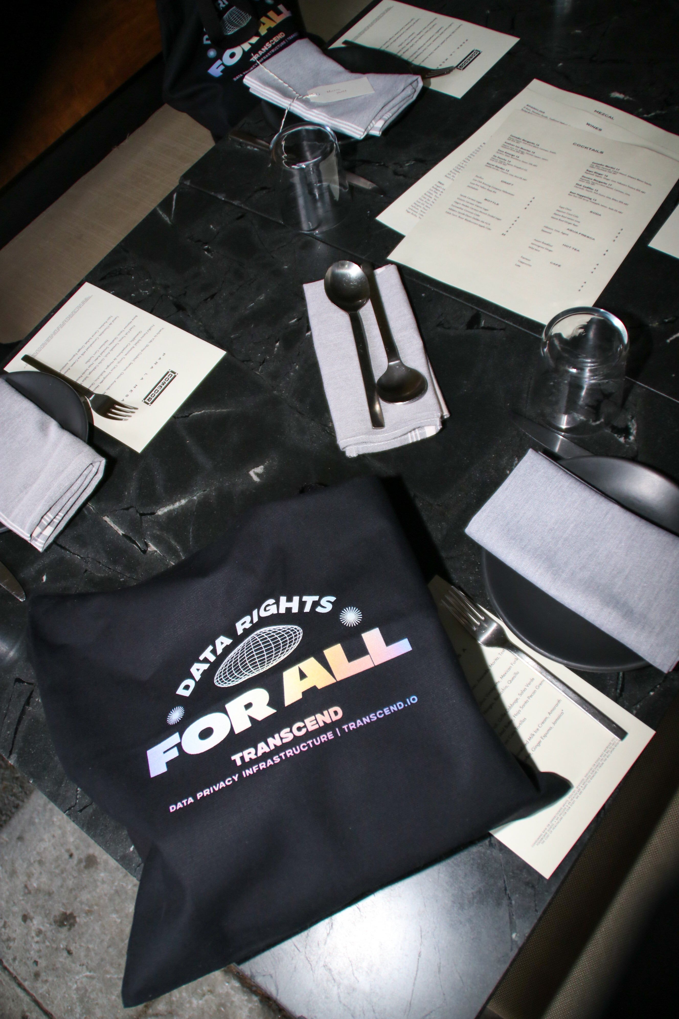 A restaurant table with a bag reading data rights for all transcend