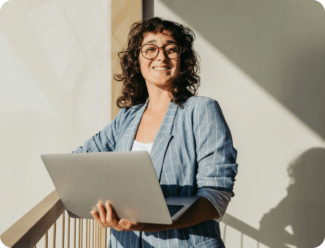 Smiling professional women holding a laptop