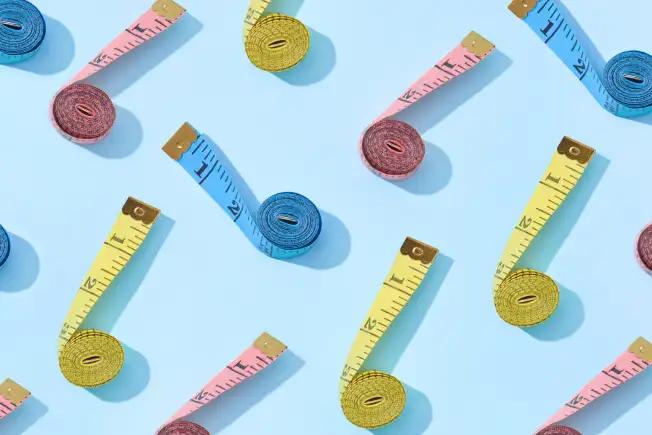 Design of several fabric tape measures of various colors on light blue background