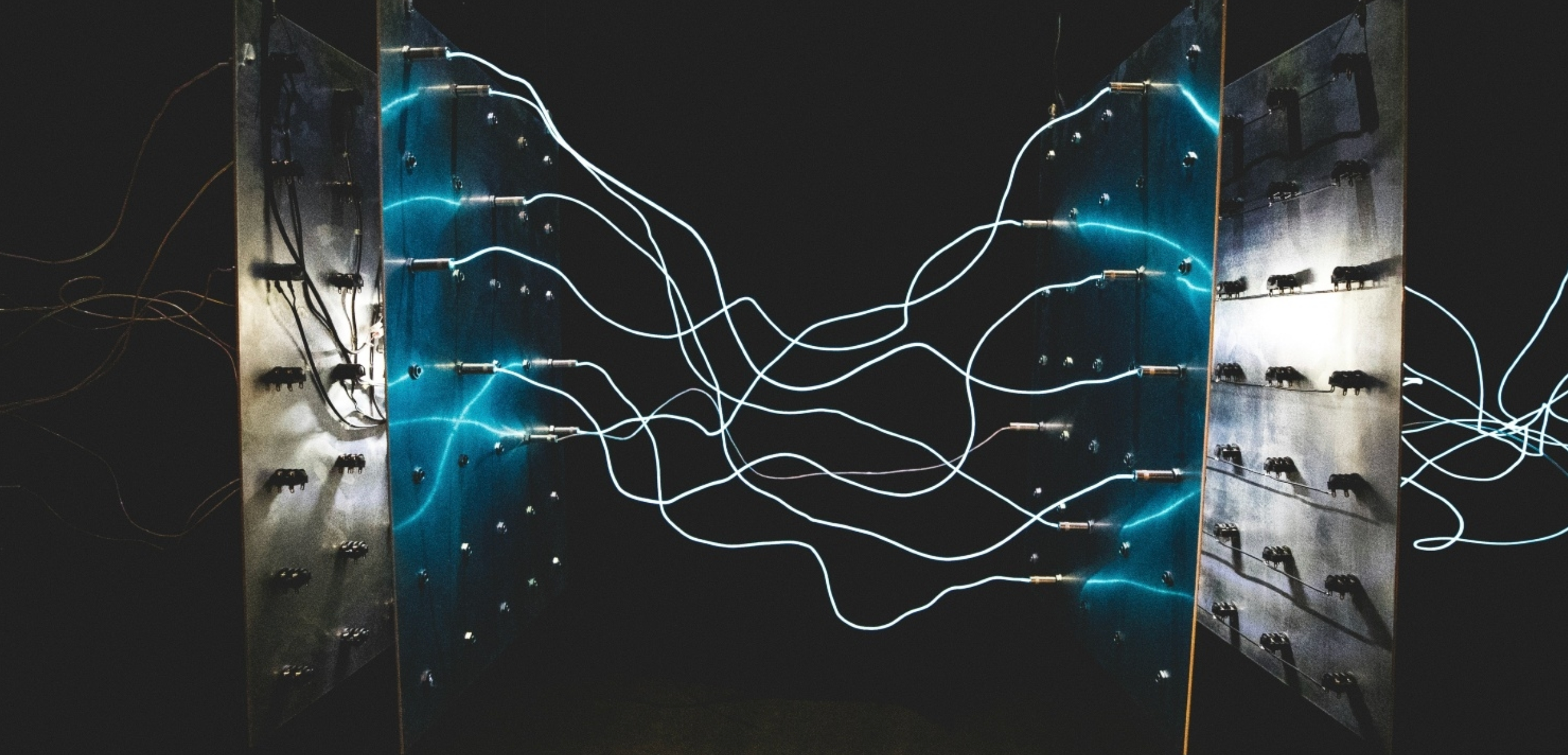 A composite image of electricity passing through wires from left to right.