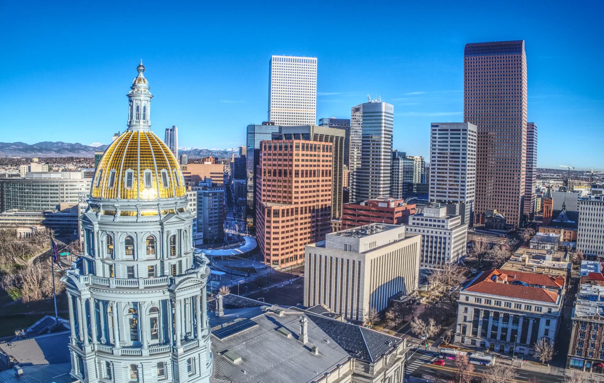 The Colorado capitol building in the foreground with the city backdropped behind it