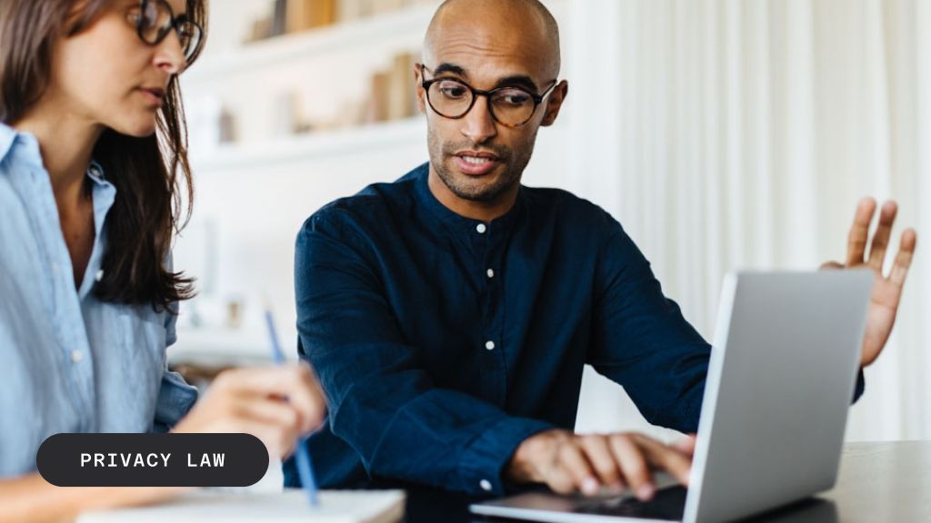 Two people working on a laptop with "PRIVACY LAW" text overlay.
