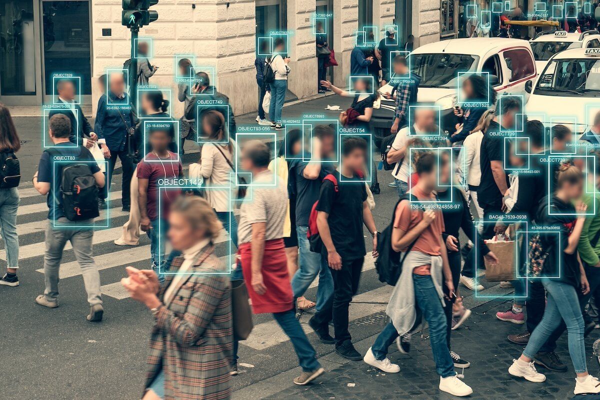 View of crowded street of pedestrians with squares overlayed on their faces implying mass surveillance in the context of AI