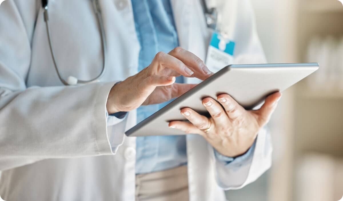 Closeup of doctor using tablet