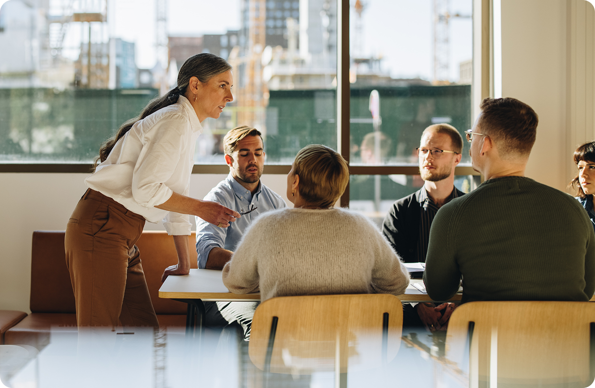 An experienced professional woman leading a team meeting