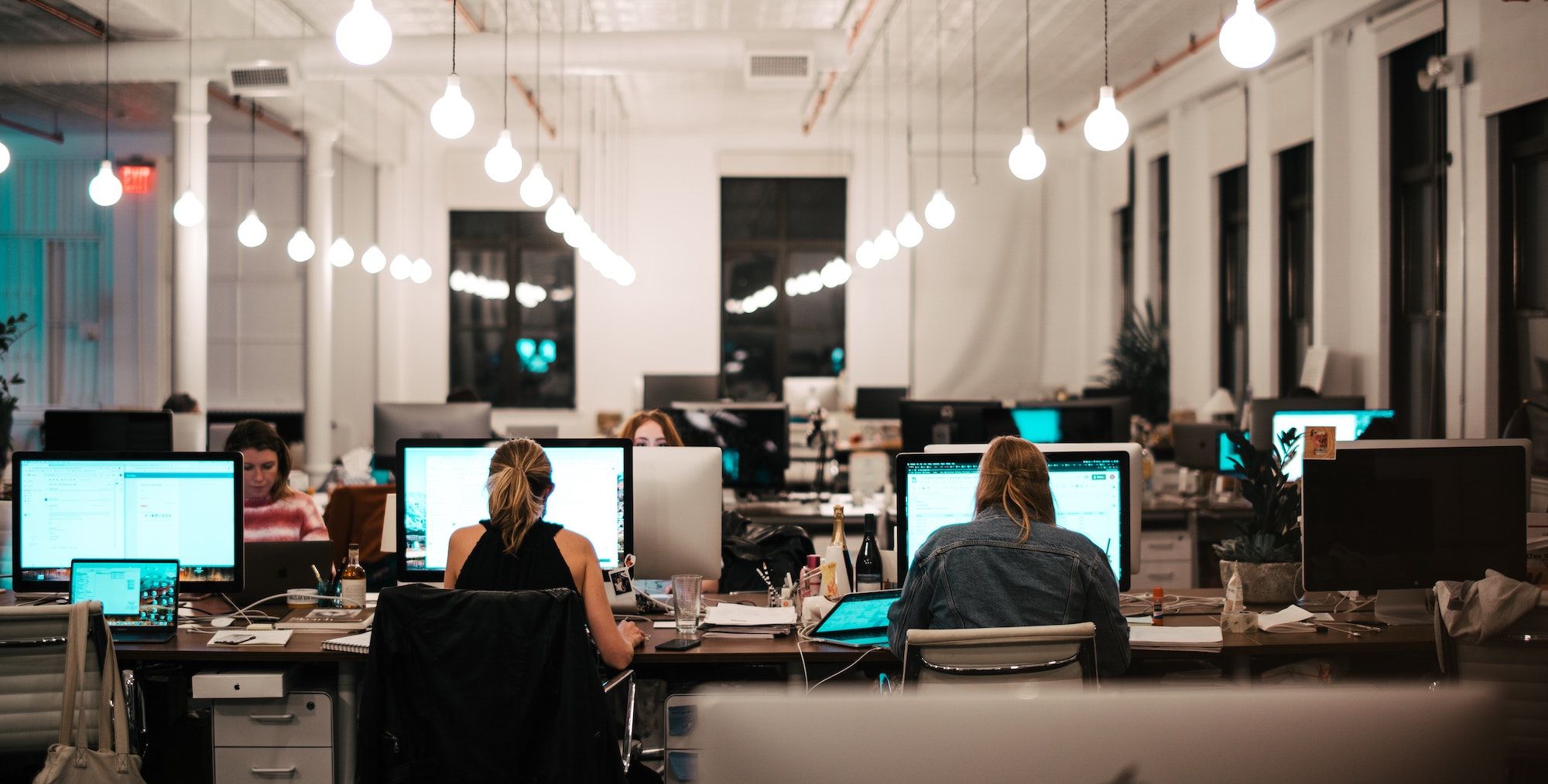 Modern office showing several professional women working on desktops