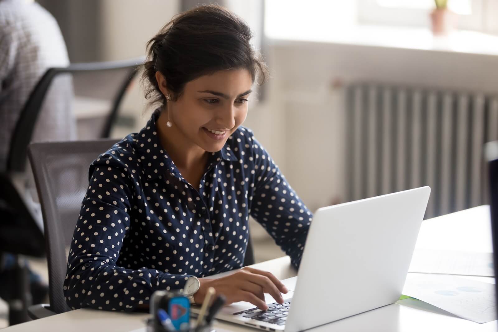 Professional woman working on laptop working on a data mapping project
