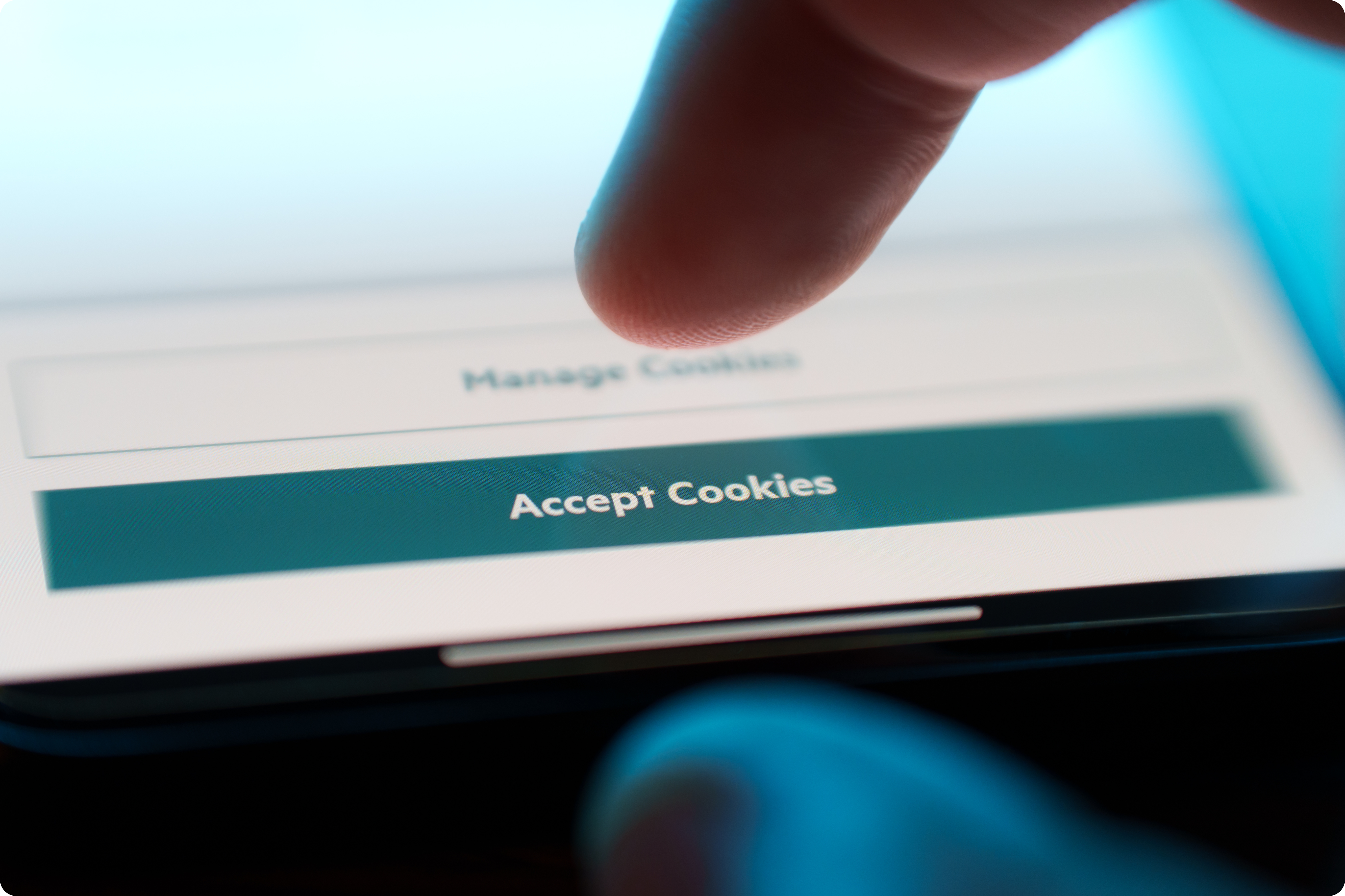 A finger is poised to tap the "Accept Cookies" button on a smartphone screen, with a "Manage Cookies" option visible above.