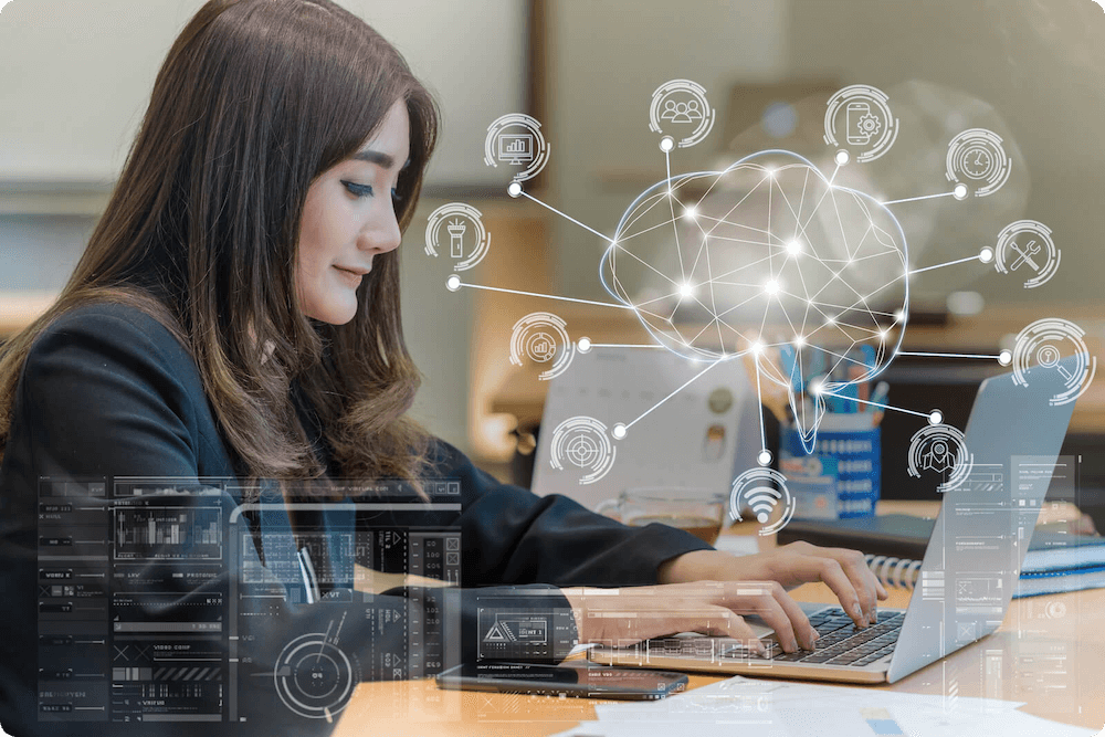 Woman using laptop with graphic overlays floating in front of it of brain interconnected with tech related logos