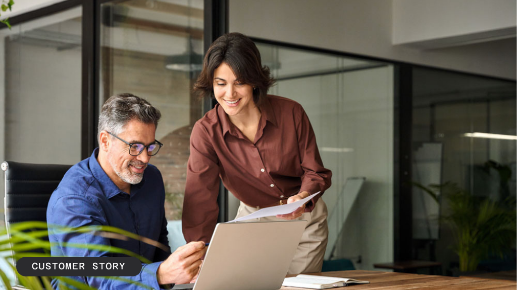 A man and a woman walk down a hallway discussing something on a tablet; the background highlights a case study for a Fortune 50 retailer focusing on retail media networks.