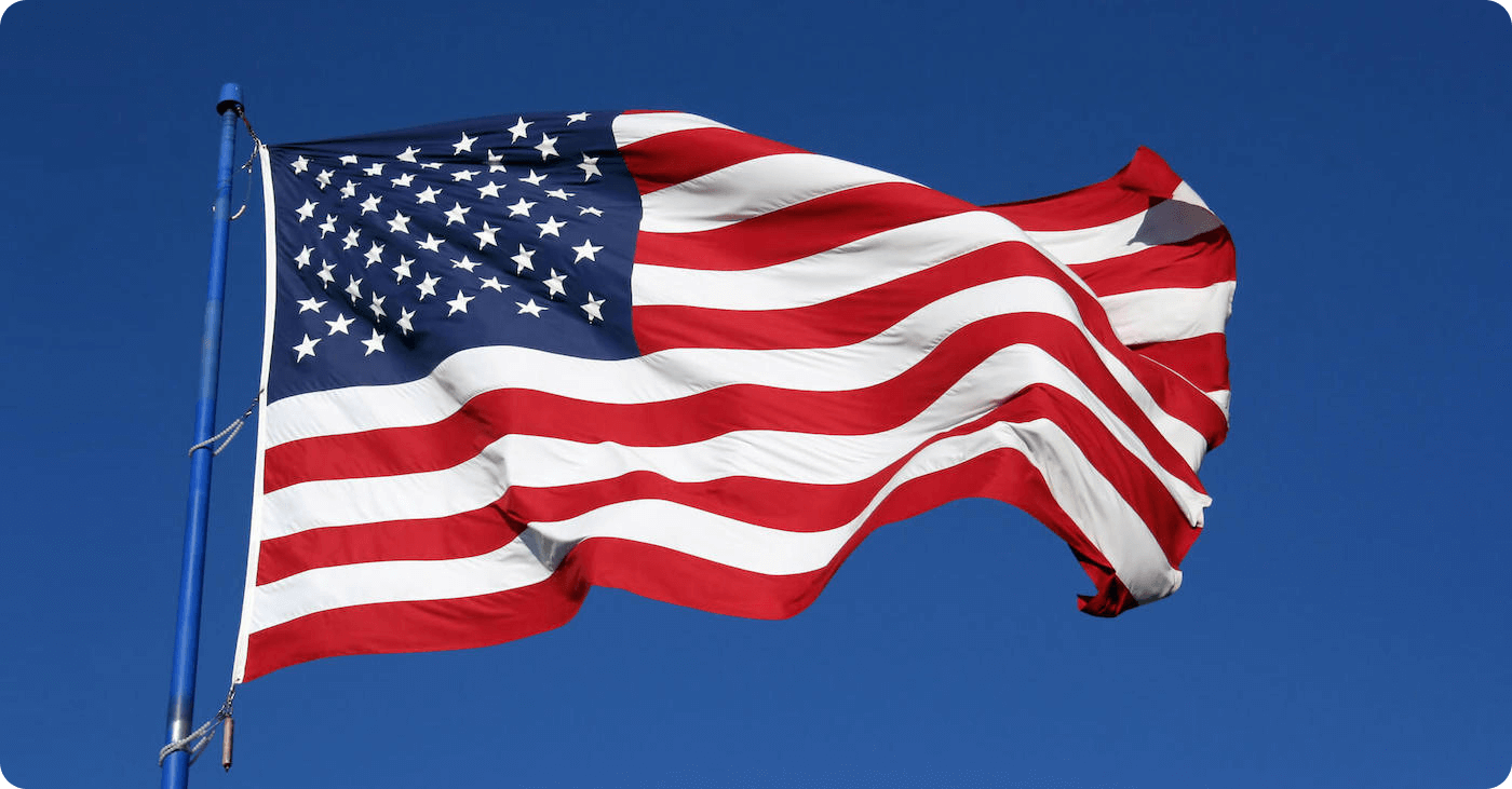 The USA flag waving in front of blue background