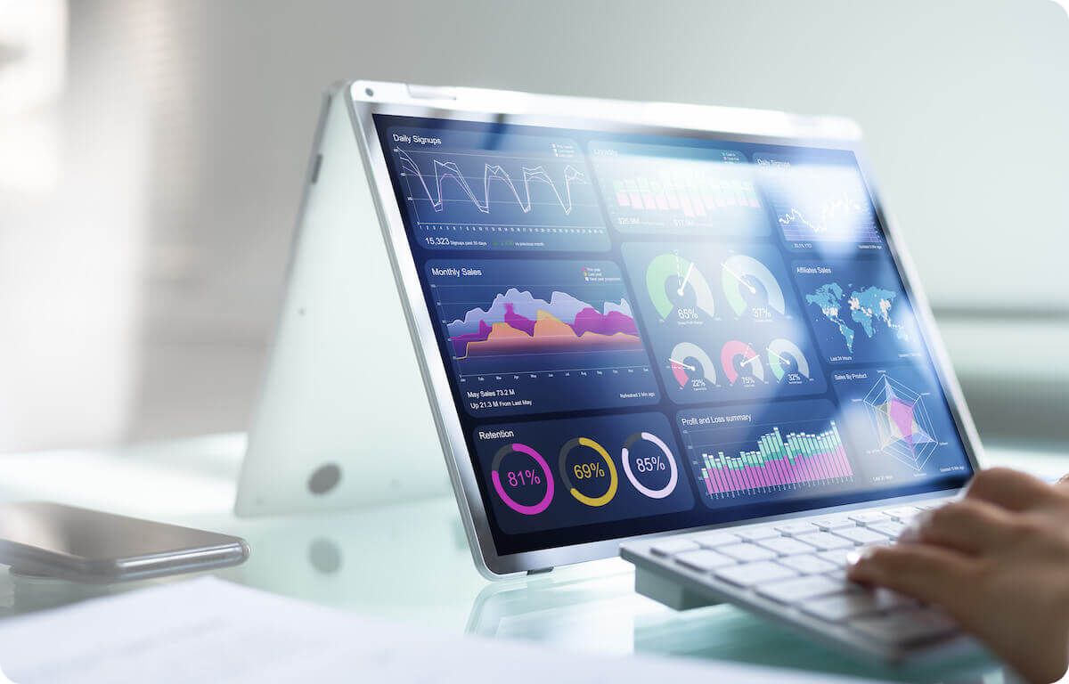 Person using fold over laptop with metric dashboard view
