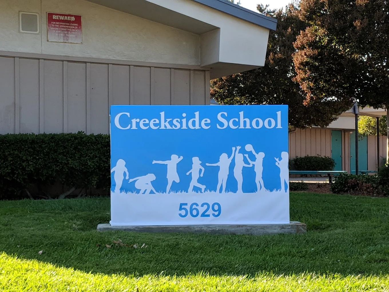Creekside School sign in front of the campus building