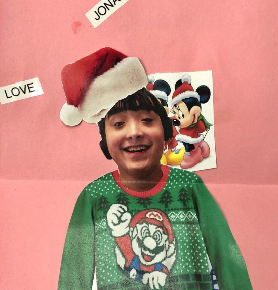 Jonah Chung smiling, wearing a holiday sweater and a Santa hat