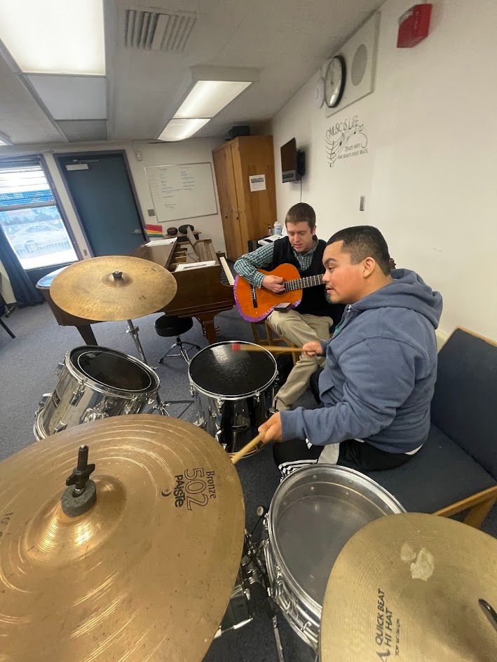 Student playing basketball on an outdoor school court